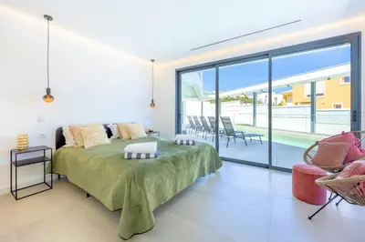 a bedroom with a large bed and a balcony at Villa Vista Albufeira Sea Views Heated Pool Walk To Marina in Albufeira