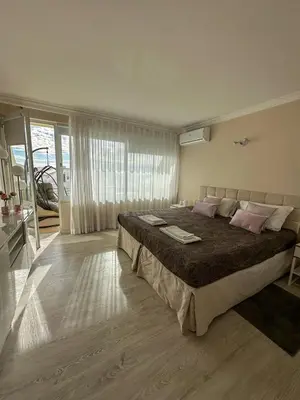a large bedroom with a large bed with pink pillows at Vilamoura View Apartment in Quarteira
