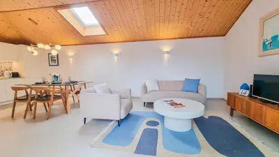 a table and chairs in a room with potted plants at Blue Haven By The Ria - Faro City in Faro