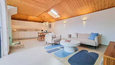 a living room with a couch and a table at Blue Haven By The Ria - Faro City in Faro