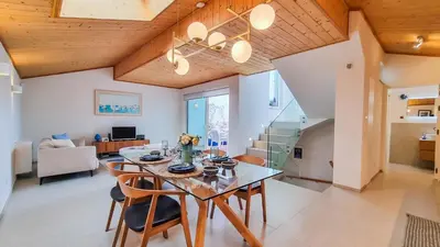 a kitchen and dining room with a table and chairs at Blue Haven By The Ria - Faro City in Faro