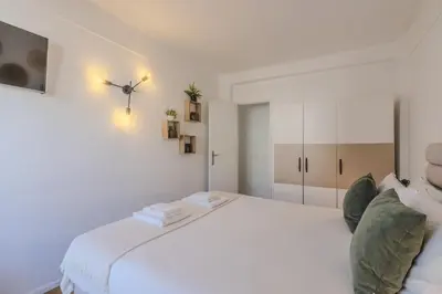 a white bedroom with a large white bed at #347 Albufeira Dream Home by Home Holidays in Albufeira