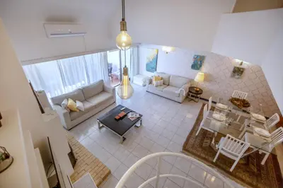 a living room with a couch and a table at Villa Lina - Vilamoura in Quarteira