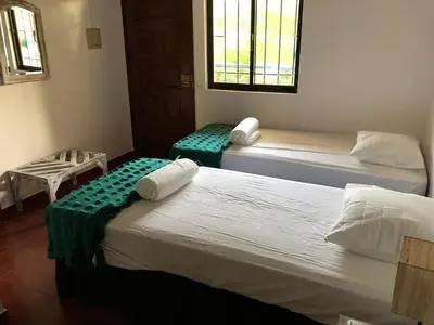 a room with two beds and a window at Beautiful T2 Apartamento Olhos do Mar in Olhos de Água