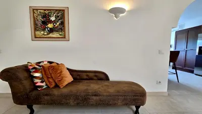 a brown couch in a living room with a painting on the wall at Villa Albatros Cleverdetails, Vilamoura, private pool and jacuzzi in Vilamoura