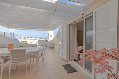 a balcony of a house with a table and chairs at Rooftop with sea views by Algarve Dream Holidays in Albufeira