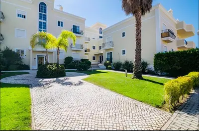 a pathway in front of a building with a palm tree at Rooftop with sea views by Algarve Dream Holidays in Albufeira