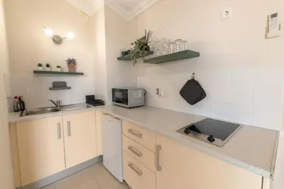 a kitchen with white cabinets and a counter top at Rooftop with sea views by Algarve Dream Holidays in Albufeira