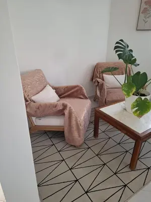 a living room with a chair and a table at Vilamoura Pinhal Golf Course in Quarteira