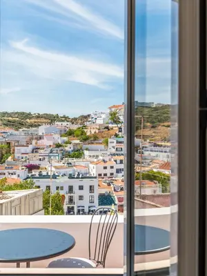 a view from the balcony of a room with a table and chairs at Casa da Porta da Praia - 3 Bedroom Castle Wall House in Albufeira