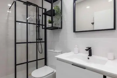 a bathroom with a toilet and a sink and a shower at Casa da Porta da Praia - 3 Bedroom Castle Wall House in Albufeira