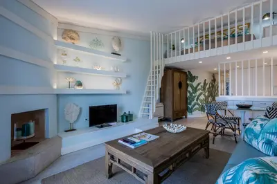 a living room with a couch and a table at The Palm Nest
