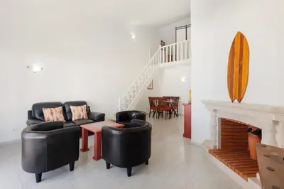 a kitchen with white cabinets and a sink at Casa Sol Dourado in Albufeira