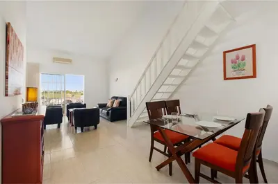 a living room with a couch and a table at Casa Sol Dourado in Albufeira