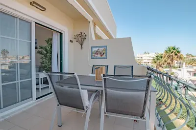 a patio with a table and chairs on a balcony at Condo-Pool walk to the Beach by Algarve Dream Holidays in Albufeira