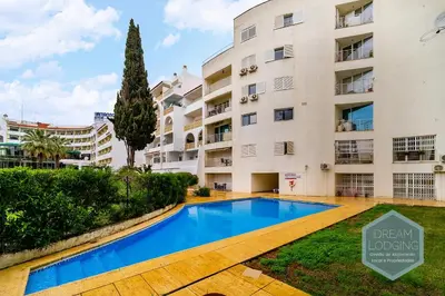 a swimming pool in front of a building at Albufeira Breeze Living - Dream Lodging in Albufeira