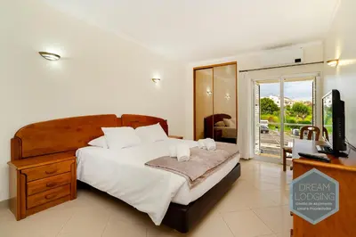 a bedroom with a bed with a television and a desk at Albufeira Breeze Living - Dream Lodging in Albufeira