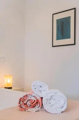 a pile of towels sitting on top of a bed at Casa Joaninha - Heated pool - Algarve in Algoz