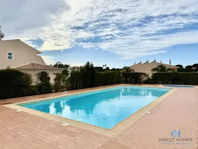 a house with a palm tree in front of it at Villa Rosal 21 in Albufeira