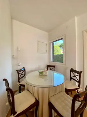 a dining room with a round table and chairs at Casa Manacá Vilamoura in Quarteira