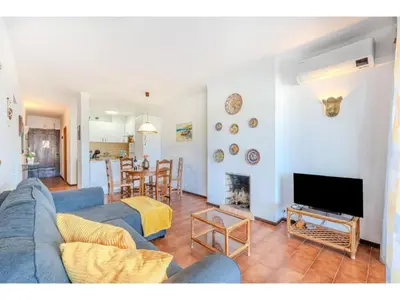 a living room with a blue couch and a table at Apartment Ivone - Sunny Way by Interhome in Albufeira