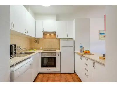 a kitchen with white cabinets and a counter top at Apartment Ivone - Sunny Way by Interhome in Albufeira