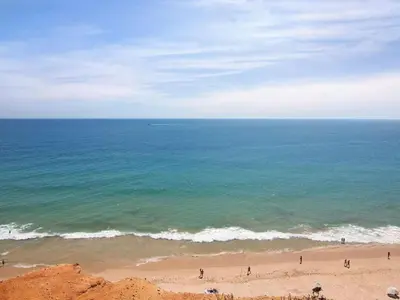 a group of people on a beach near the ocean at Apartment Kaya- Sunny Way by Interhome in Albufeira