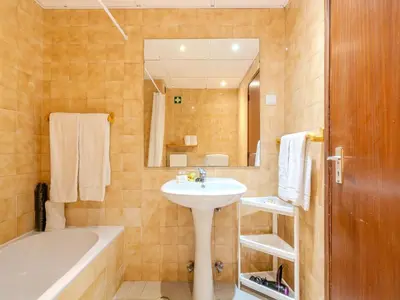 a room with two beds and a table between them at Apartment Lima - Sunny Way by Interhome in Albufeira