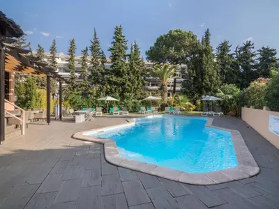 a group of lounge chairs and a swimming pool at Apartment Malick - Sunny Way by Interhome in Albufeira