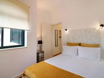 a bedroom with a white bed and two pictures on the wall at Apartment Medusa - Sunny Way by Interhome in Albufeira