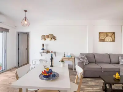 a kitchen and living room with a white table and chairs at Apartment Patrick - Sunny Way by Interhome in Albufeira