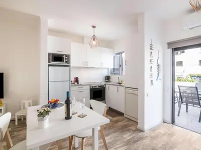 a kitchen and living room with a table and a couch at Apartment Patrick - Sunny Way by Interhome in Albufeira