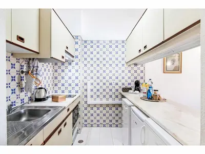 a kitchen with white cabinets and a sink in it at Apartment Anamar - Sunny Way by Interhome in Albufeira