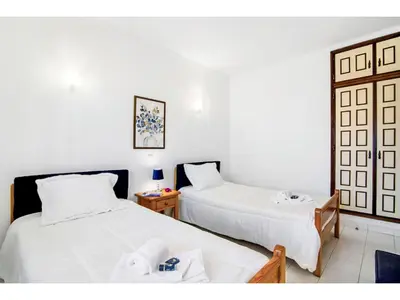 a hotel room with two beds and a table at Apartment Anamar - Sunny Way by Interhome in Albufeira