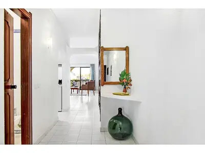 a hallway with a mirror and a vase on a shelf at Apartment Anamar - Sunny Way by Interhome in Albufeira