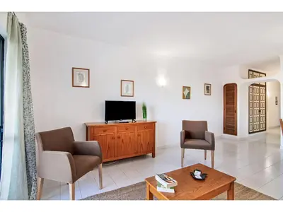 a living room with two chairs and a flat screen tv at Apartment Anamar - Sunny Way by Interhome in Albufeira