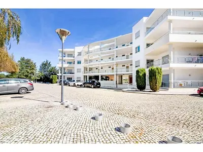 a large white building with cars parked in front of it at Apartment Loft 39 - Sunny Way by Interhome in Albufeira