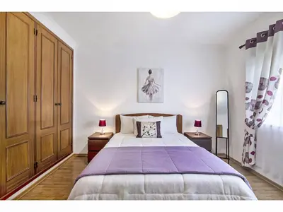a bedroom with a large bed and two night stands at Apartment Manelito House - Sunny Way by Interhome in Albufeira