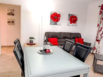 a dining room with a white table and a couch at Apartment Manelito House - Sunny Way by Interhome in Albufeira