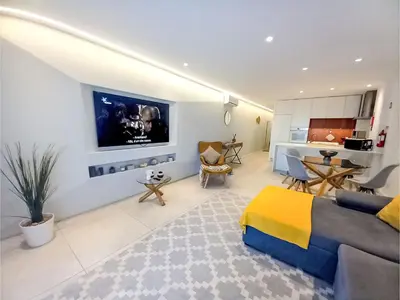 a living room with a bed and a kitchen at Apartment Sunlight Albufeira - Sunny Way by Interhome in Albufeira