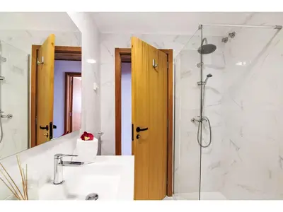 a bathroom with a shower and a sink and a mirror at Apartment W Marina - Sunny Way by Interhome in Albufeira