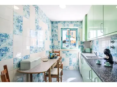 a kitchen with blue and white tiles on the walls at Apartment W Marina - Sunny Way by Interhome in Albufeira