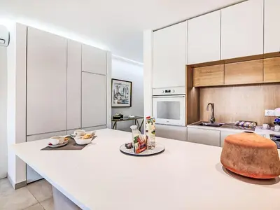 a kitchen with white cabinets and a white counter top at Apartment Albufeira Prestige - Sunny Way by Interhome in Albufeira