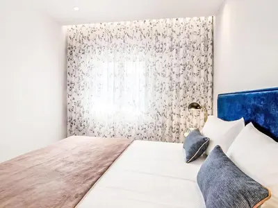 a bedroom with a large bed with a window at Apartment Albufeira Prestige - Sunny Way by Interhome in Albufeira