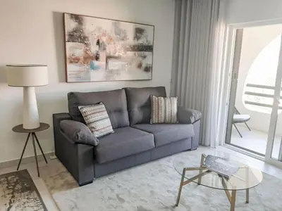 a living room with a couch and a table at Apartment Albufeira Prestige - Sunny Way by Interhome in Albufeira
