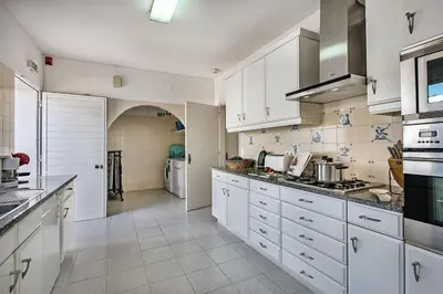 a patio with a table and chairs and a pizza oven at 4 Beds, Golf Views, optional pool heating in Vilamoura