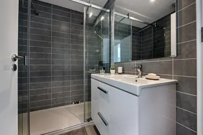 a bathroom with a white sink and a shower at Lovely Modern Apartment With Pool in Albufeira
