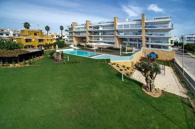 an aerial view of a large apartment building with a swimming pool at Lovely Modern Apartment With Pool in Albufeira