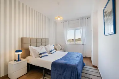 a bed with yellow and white pillows on it at Boat Apartments Old Town by Ocvillas in Albufeira