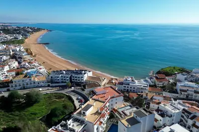a bedroom with a large bed with white walls at Boat Apartments Old Town by Ocvillas in Albufeira